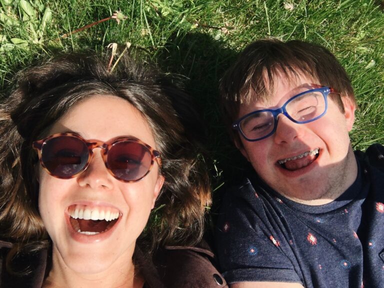 woman and man smiling on the grass
