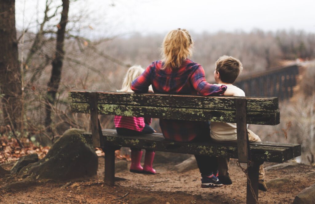 woman and two children on bench