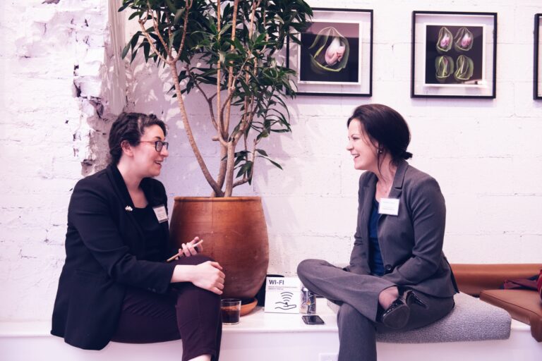 two women smiling and talking