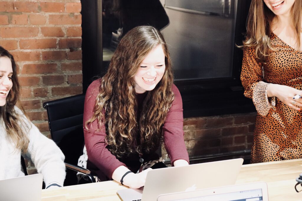 women in workgroup smiling