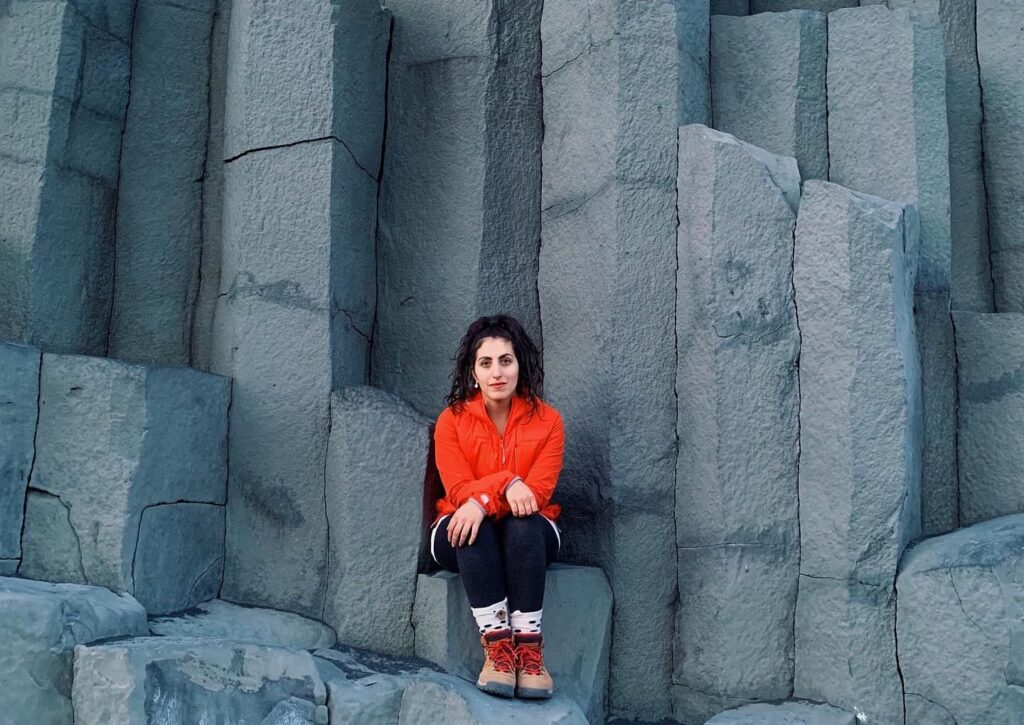 Shadi Garman sitting on rock formation