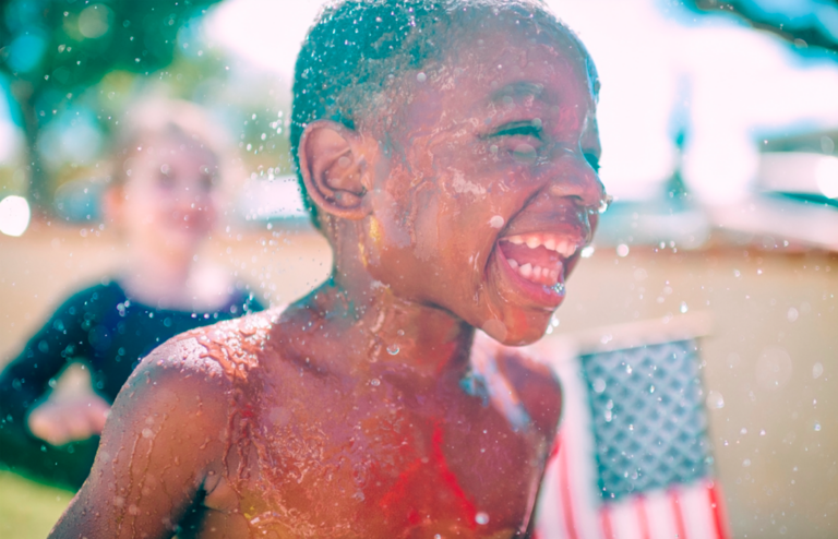 young boy playing in the water