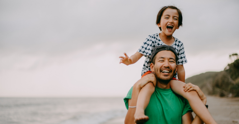 father gives daughter piggyback ride