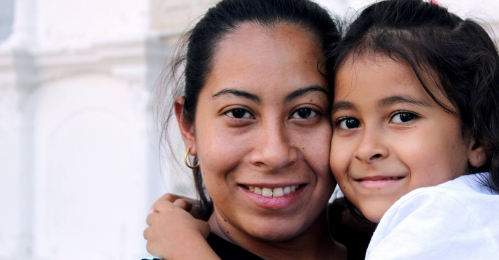 Mother holding young daughter