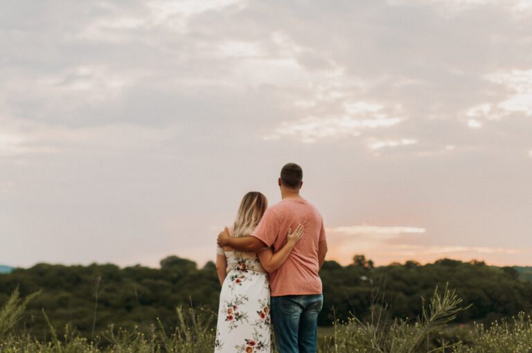 couple hugging looking at scenic view