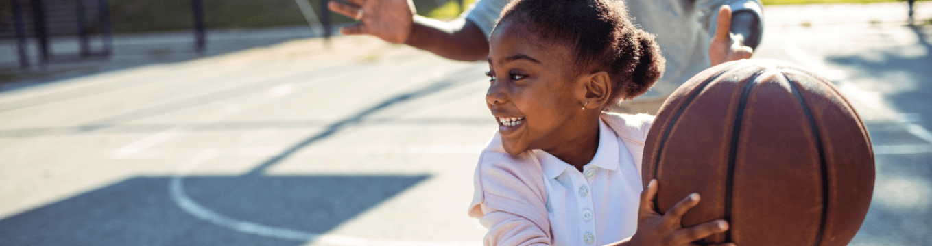 young girl playing basketball