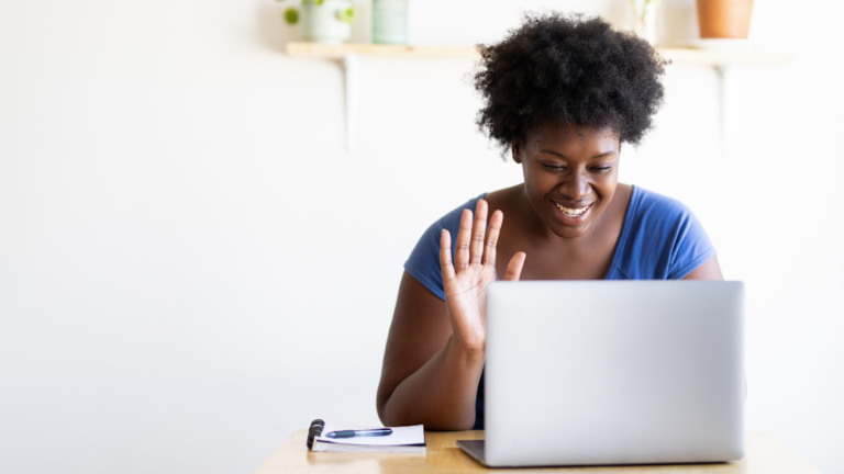 woman waving at a screen